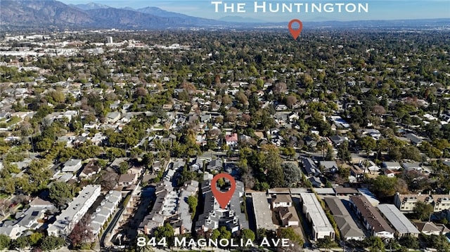 drone / aerial view featuring a residential view and a mountain view