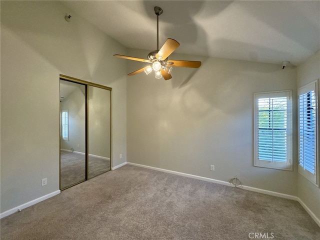 unfurnished bedroom with ceiling fan, carpet floors, a closet, and baseboards