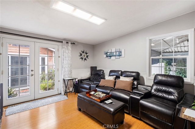 home theater with french doors and light wood-type flooring