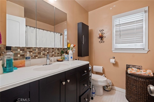 bathroom featuring backsplash, toilet, tile patterned floors, and vanity