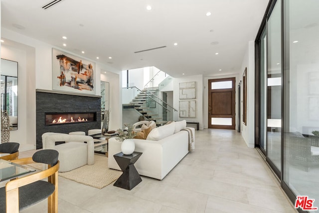 living room with floor to ceiling windows and a healthy amount of sunlight