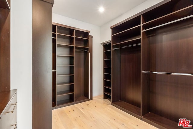 walk in closet featuring light hardwood / wood-style flooring