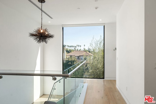 hallway featuring expansive windows and light wood-type flooring