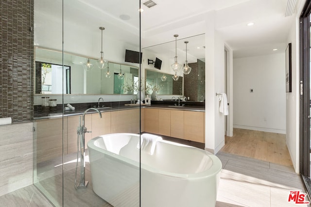 bathroom with vanity and a bathing tub