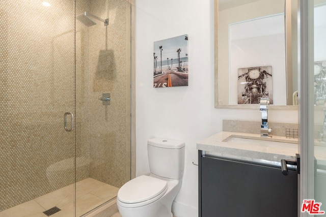 bathroom featuring vanity, walk in shower, and toilet