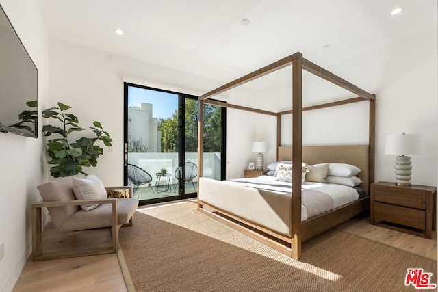 bedroom with access to exterior and light wood-type flooring