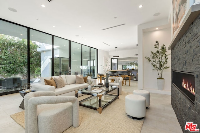 living room with floor to ceiling windows and a fireplace