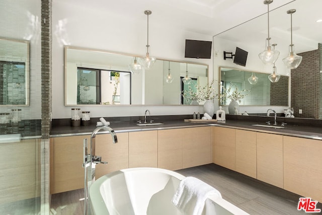 bathroom featuring hardwood / wood-style floors, vanity, and a washtub