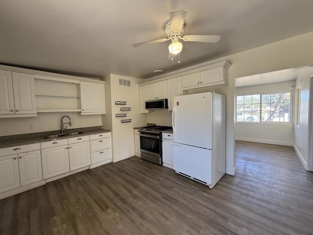 kitchen featuring ceiling fan, sink, white cabinetry, dark hardwood / wood-style floors, and stainless steel appliances