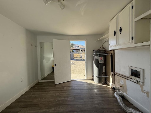 laundry area with dark wood-type flooring and secured water heater