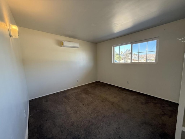 unfurnished room featuring dark colored carpet and an AC wall unit