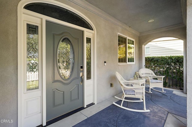 view of exterior entry featuring covered porch