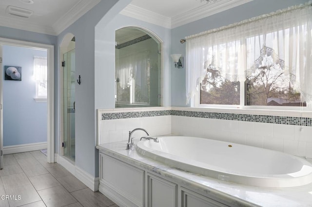 bathroom featuring crown molding, plenty of natural light, and separate shower and tub