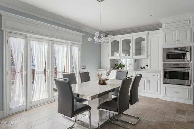 dining room with crown molding and a chandelier