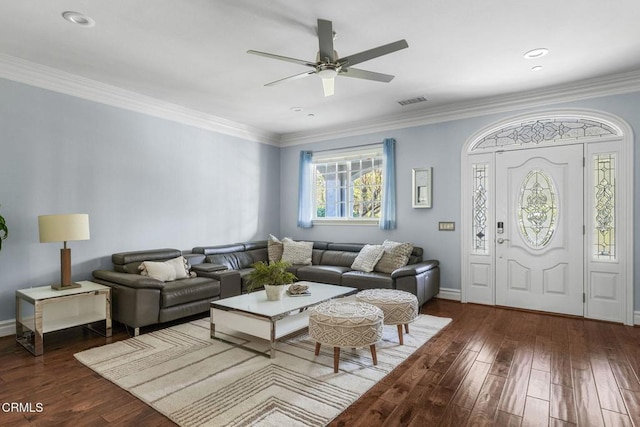 living room with dark hardwood / wood-style flooring, ornamental molding, and ceiling fan