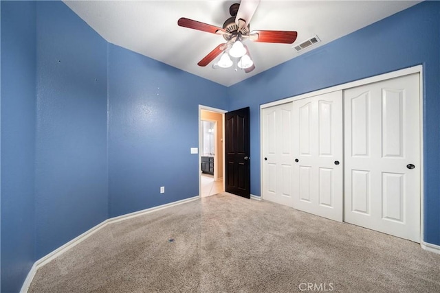 unfurnished bedroom featuring a closet, ceiling fan, and carpet flooring