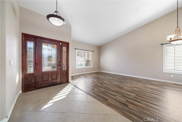 tiled entryway featuring lofted ceiling