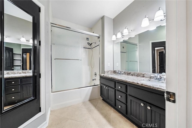 bathroom with vanity, combined bath / shower with glass door, and tile patterned flooring