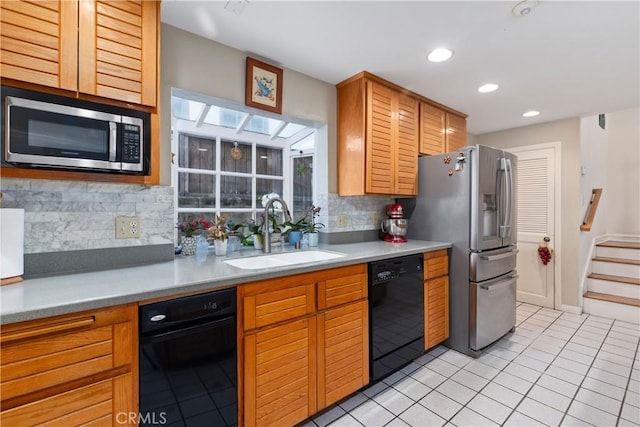 kitchen with sink, light tile patterned flooring, tasteful backsplash, and stainless steel appliances