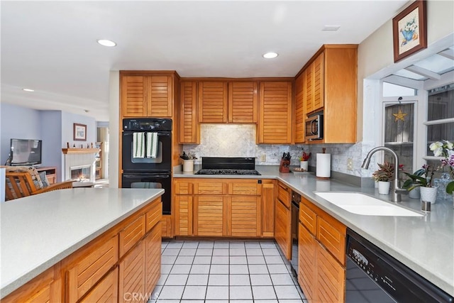 kitchen with sink, backsplash, light tile patterned floors, and black appliances