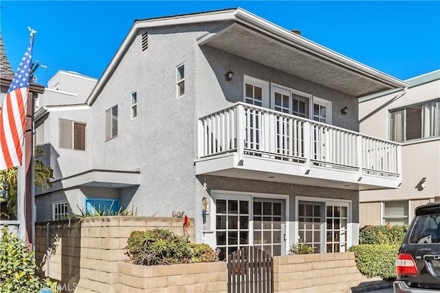 rear view of property with a balcony