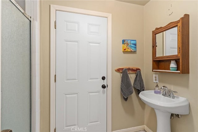 bathroom featuring sink and an enclosed shower