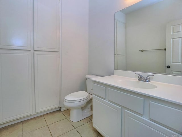 bathroom featuring toilet, vanity, and tile patterned flooring