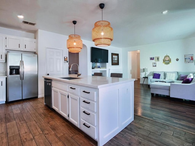 kitchen featuring stainless steel refrigerator with ice dispenser, sink, decorative light fixtures, and white cabinets