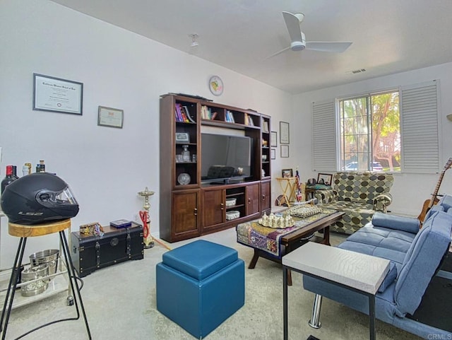 living room featuring carpet and ceiling fan