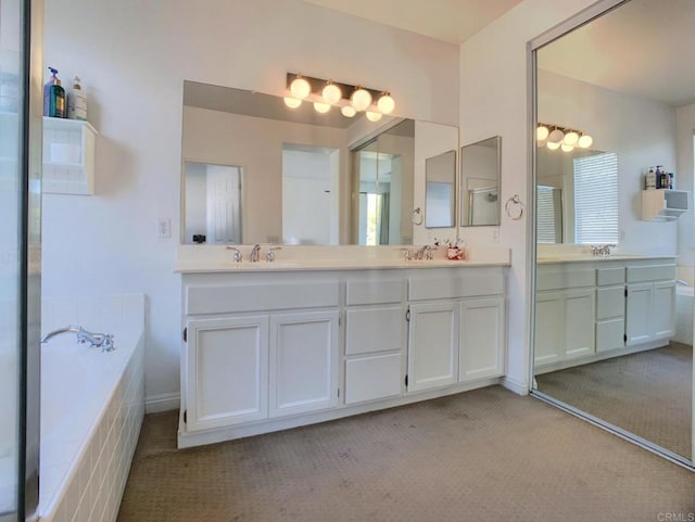 bathroom with tiled bath and vanity