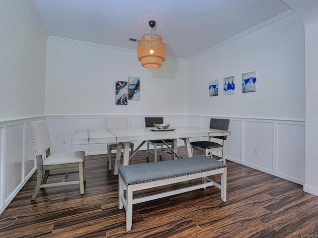 dining area with breakfast area, dark hardwood / wood-style floors, and ornamental molding