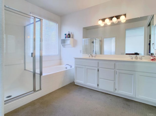 bathroom with vanity and separate shower and tub