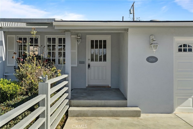 view of exterior entry with a garage