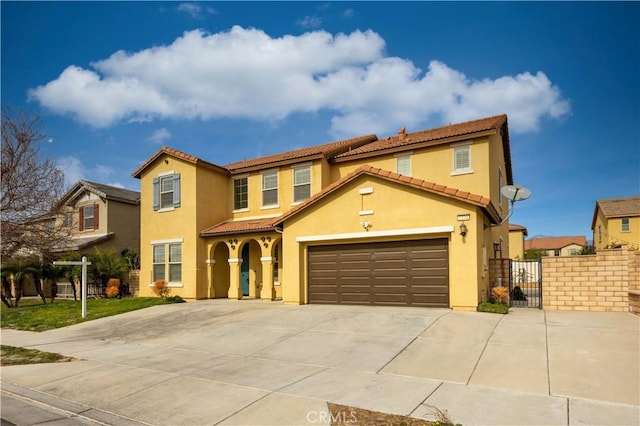 mediterranean / spanish home with a garage