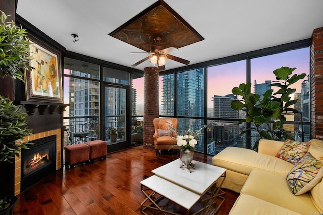 living room featuring expansive windows, ceiling fan, and dark wood-type flooring