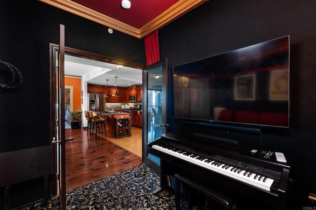 misc room with hardwood / wood-style floors and crown molding