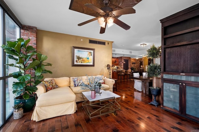 living room featuring ceiling fan and dark hardwood / wood-style floors