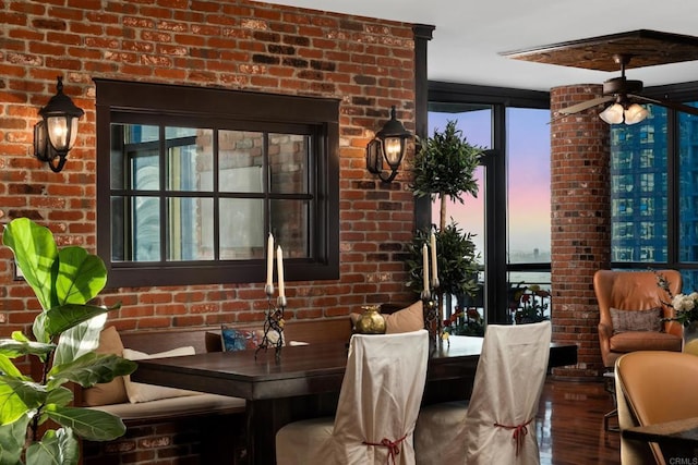 dining room with wood-type flooring and brick wall