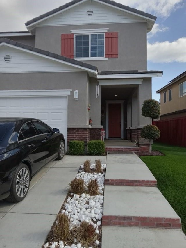 front of property featuring a garage and a front lawn