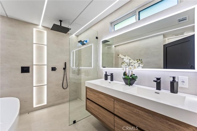 bathroom featuring vanity, tile patterned floors, and shower with separate bathtub