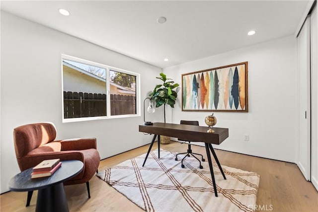 home office with light hardwood / wood-style floors