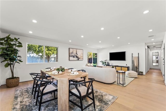 dining space featuring light wood-type flooring and a wealth of natural light