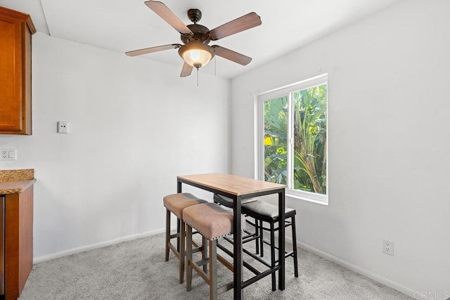 dining room featuring light colored carpet and ceiling fan