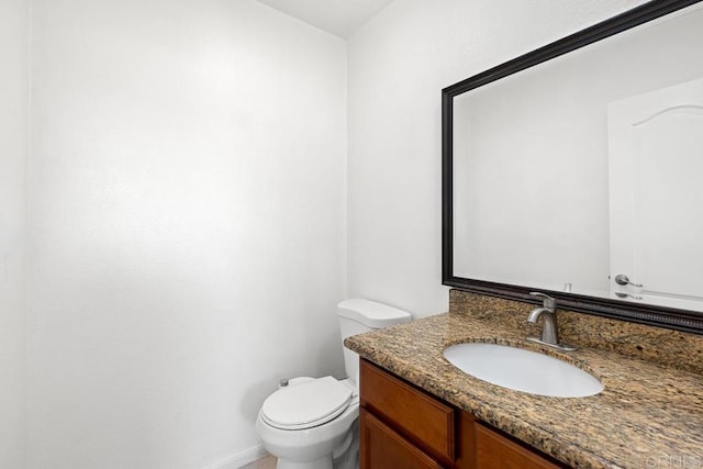 bathroom with toilet and vanity