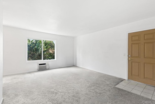 carpeted spare room featuring an AC wall unit