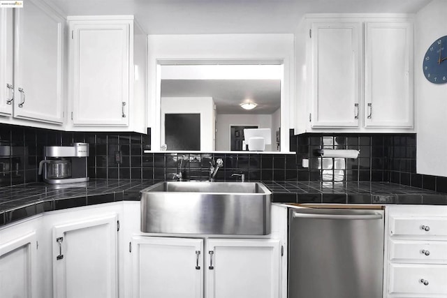 kitchen with sink, white cabinetry, dishwasher, and tile counters