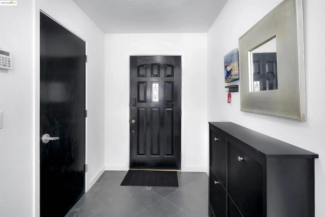 foyer with dark tile patterned floors