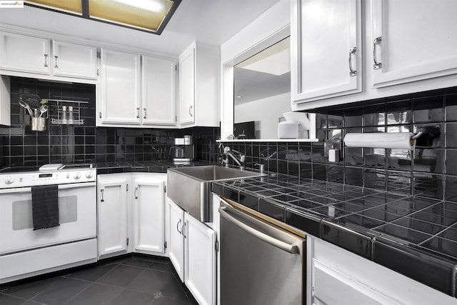 kitchen featuring white electric range oven, dishwasher, white cabinets, and tile counters