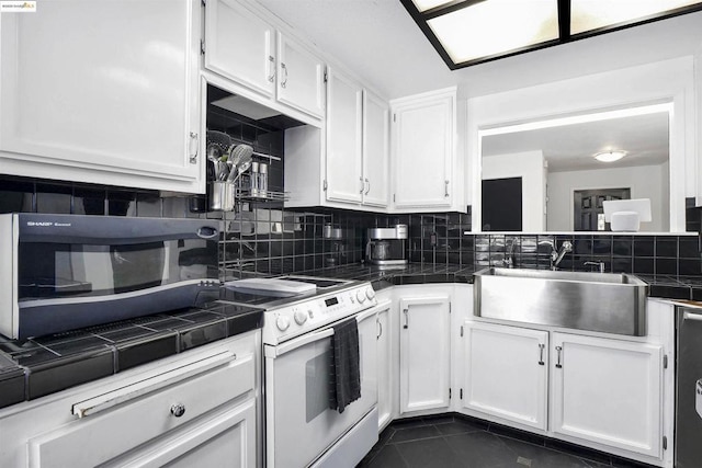 kitchen with sink, tile countertops, and white cabinetry