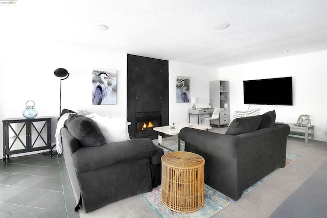 tiled living room with a large fireplace and a textured ceiling